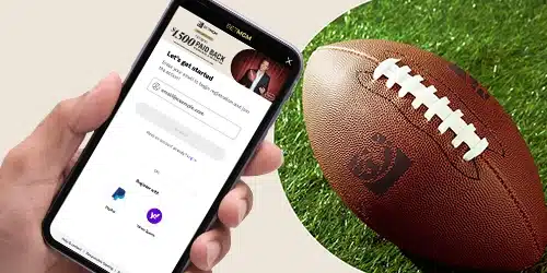 BetMGM registration banner with a hand holding a mobile phone with the BetMGM mobile app, next to a football