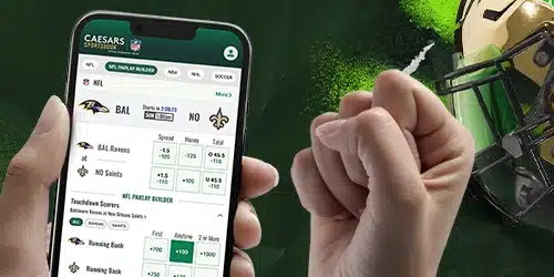 Caesars sportsbook registration banner with a hand holding a mobile phone with the Caesars mobile app, beside a football helmet